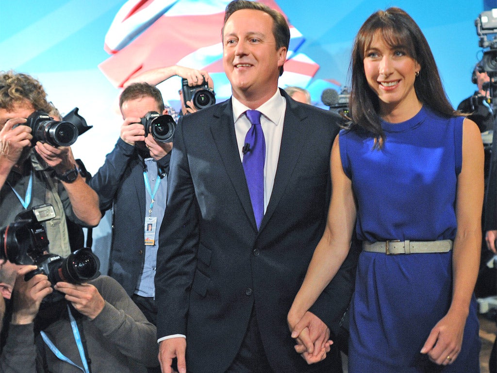 David Cameron and wife Samantha are pictured following his speech