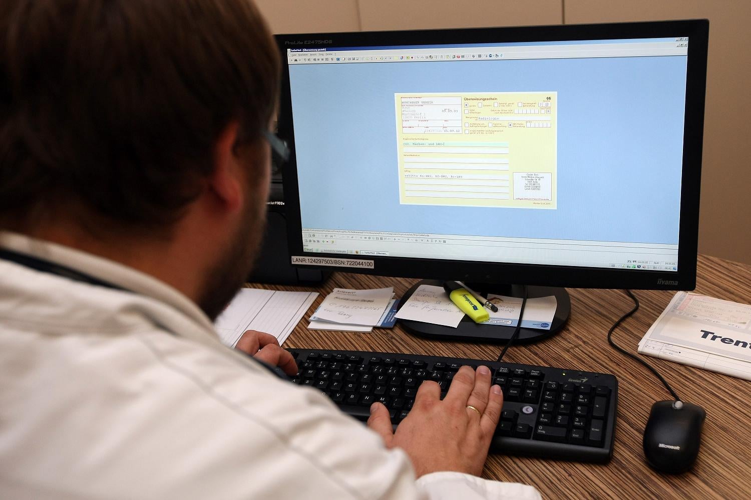 A doctor prepares a prescription on a computer screen. All of Google's new information has been checked by real doctors