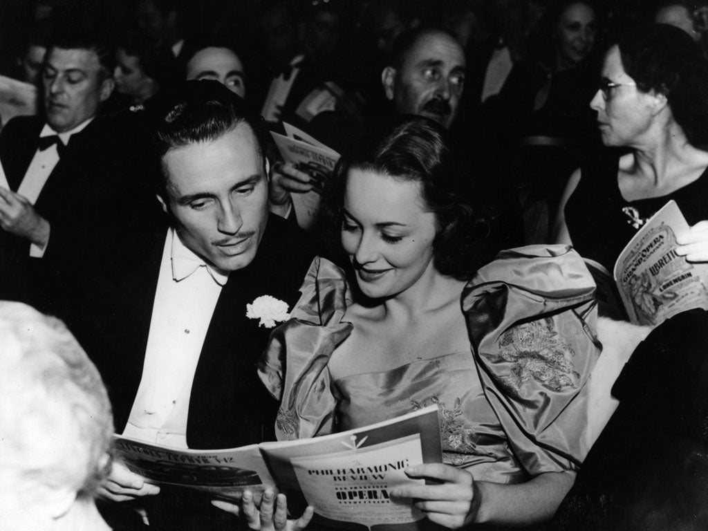 circa 1939: Hollywood screen star Olivia De Havilland at the opera with American actor Billy Bakewell