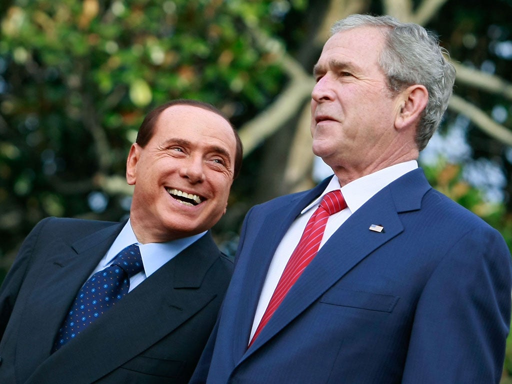 President George W. Bush (R) and Italian Prime Minister Silvio Berlusconi (L) participate in a South Lawn arrival ceremony at the White House October 13, 2008