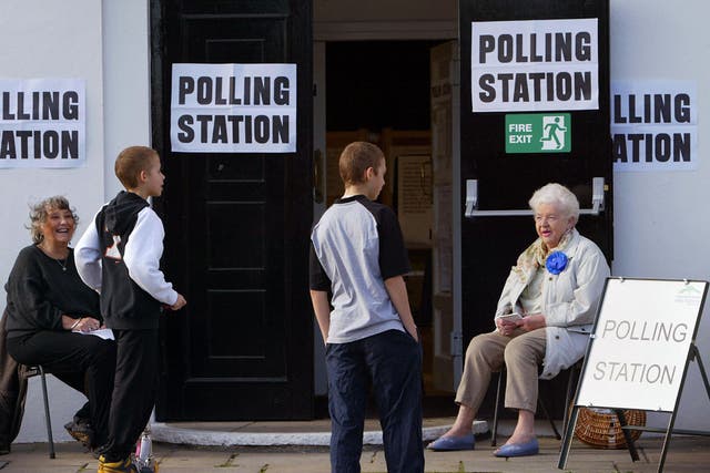 Teenagers make a request to vote at a polling station in Stanwell Village, west of London 05 May 2005.