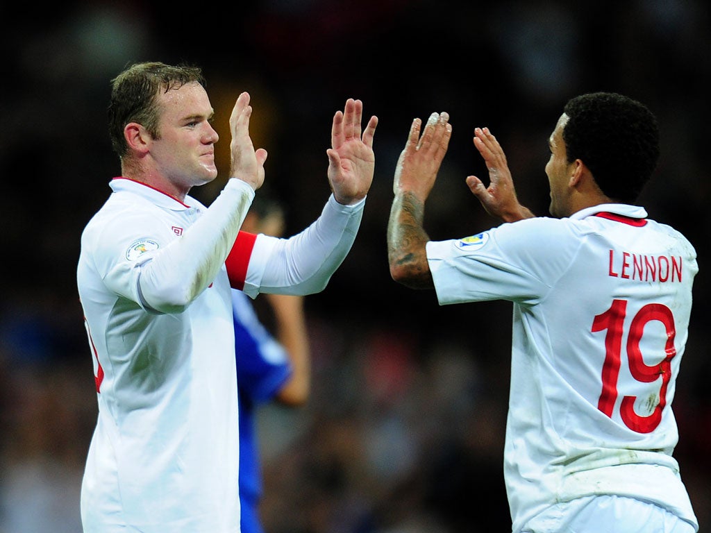 Wayne Rooney and Aaron Lennon celebrate England's third goal