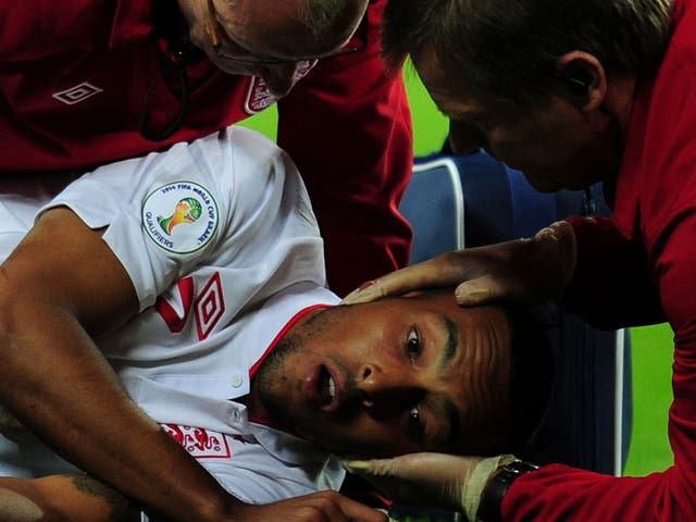 Theo Walcott is treated after colliding with Aldo Simoncini