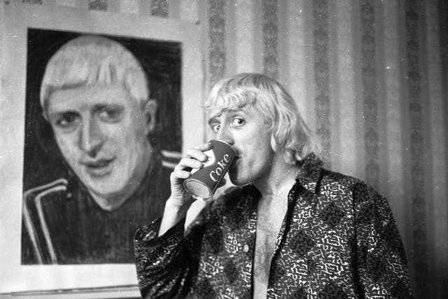 Savile in his Bloomsbury hotel room in 1965, in front of a portrait of himself