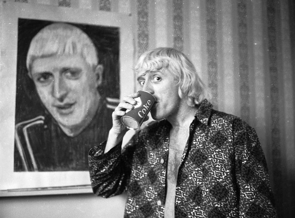 Savile in his Bloomsbury hotel room in 1965, in front of a portrait of himself