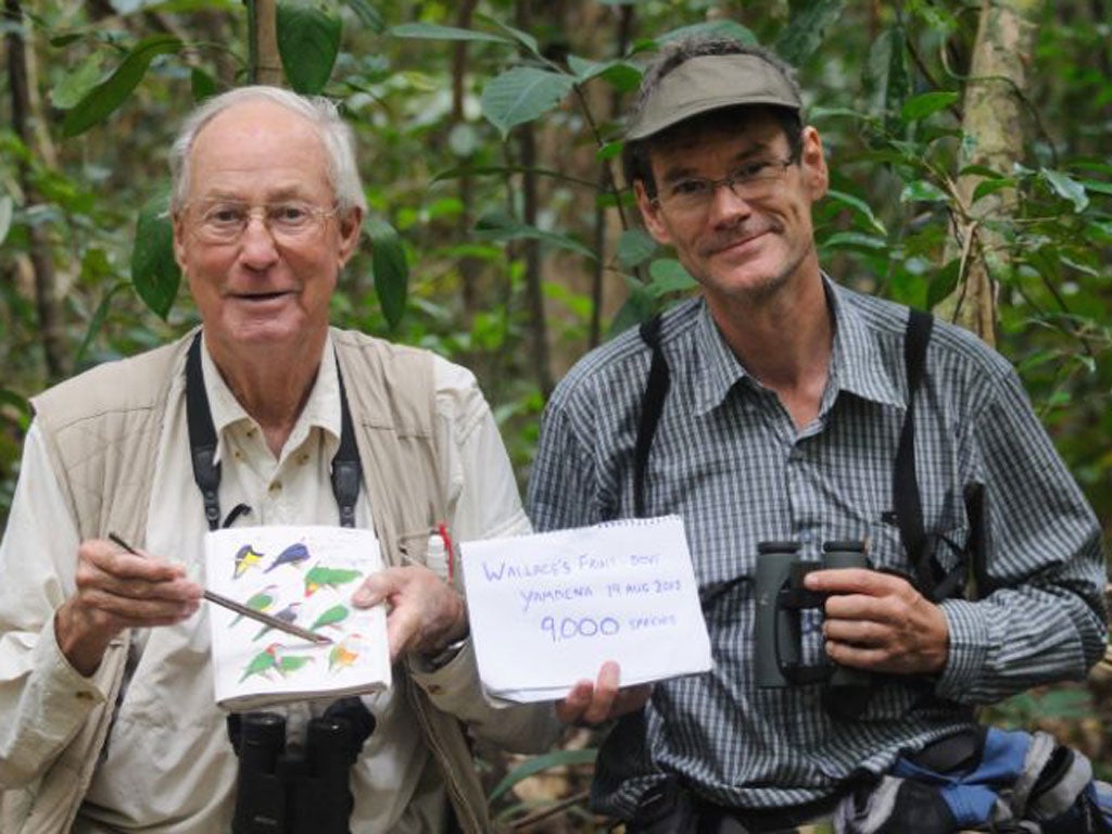 Tom Gullick, left, with bird guide Frank Lambert, after spotting the Wallace’s fruit dove in Indonesia