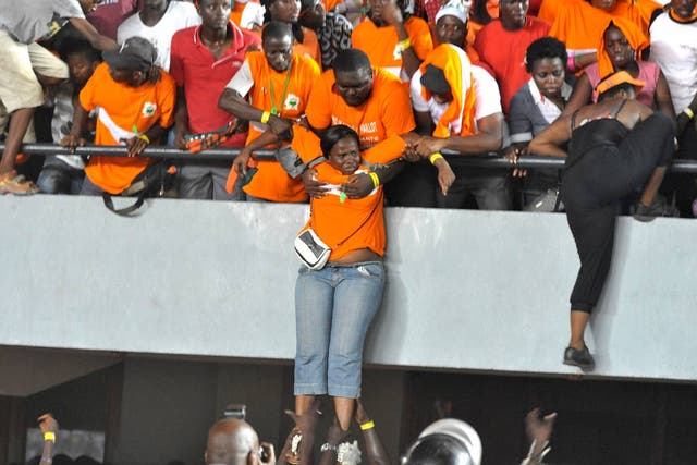 Ivory Coast fans look to flee the stands