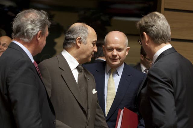 From left, Luxembourg's Foreign Minister Jean Asselborn, French Foreign Minister Laurent Fabius, Foreign Secretary William Hague and German Foreign Minister Guido Westerwelle share a word during the meeting of EU foreign ministers in Luxembourg