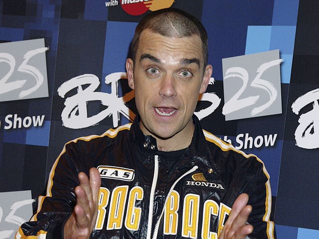 Singer Robbie Williams and winner of the Brits-25 Best Song for 'Angels' poses in the press room during the 25th Anniversary BRIT Awards 2005