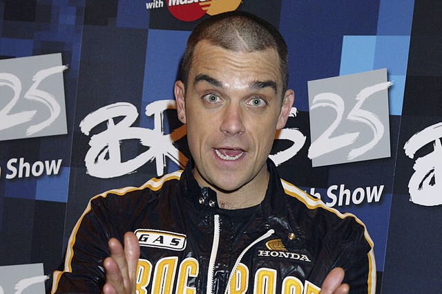 Singer Robbie Williams and winner of the Brits-25 Best Song for 'Angels' poses in the press room during the 25th Anniversary BRIT Awards 2005