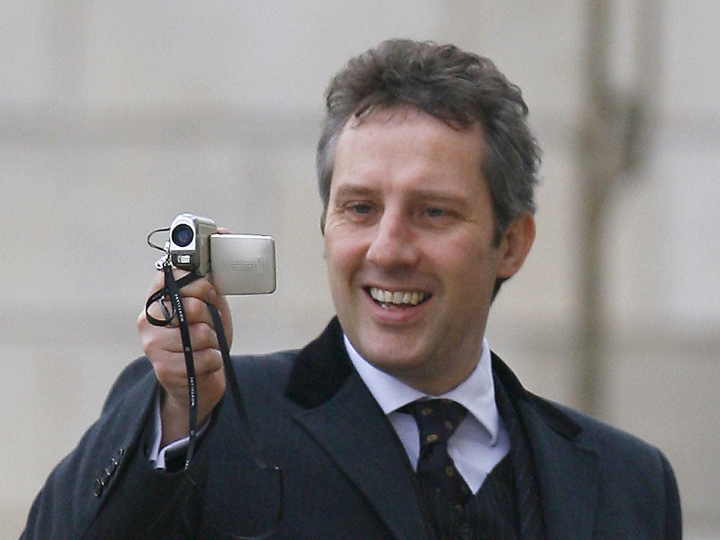 The son of the leader of the Democratic Unionist Party (DUP) Ian Paisley, Ian Paisley Jr., videos the press as as he arrives at Stormont in Belfast, Northern Ireland, 26 March 2007