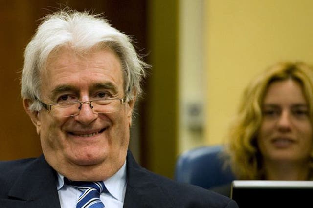 Radovan Karadzic smiles as he starts his defence at the UN war crimes tribunal