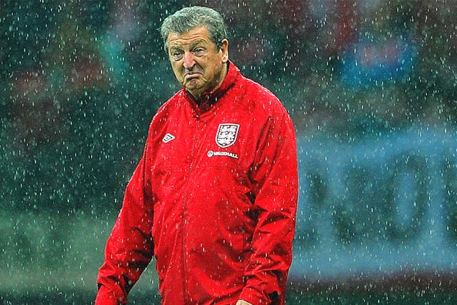 Roy Hodgson inspects the pitch at the National Stadium in Warsaw