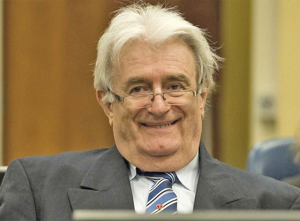 Radovan Karadzic sits in the courtroom on the first day of his defense against war crime charges