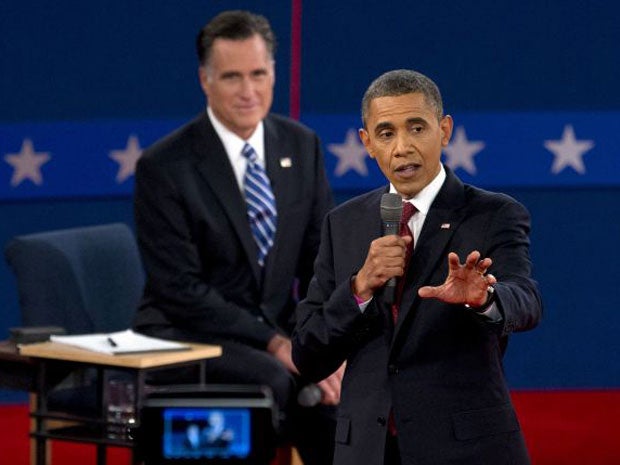 President Barack Obama speaks as Republican presidential candidate Mitt Romney listens during the second Presidential debate