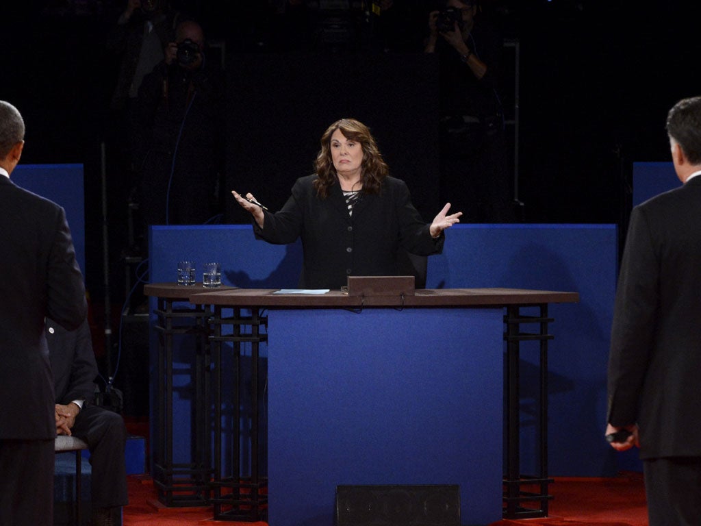 U.S. President Barack Obama (L) and Republican presidential candidate Mitt Romney (R) listen to moderator Candy Crowley (C) during a town hall style debate at Hofstra University October 16, 2012 in Hempstead, New York.
