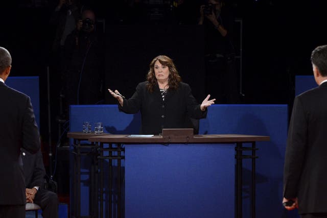 U.S. President Barack Obama (L) and Republican presidential candidate Mitt Romney (R) listen to moderator Candy Crowley (C) during a town hall style debate at Hofstra University October 16, 2012 in Hempstead, New York.