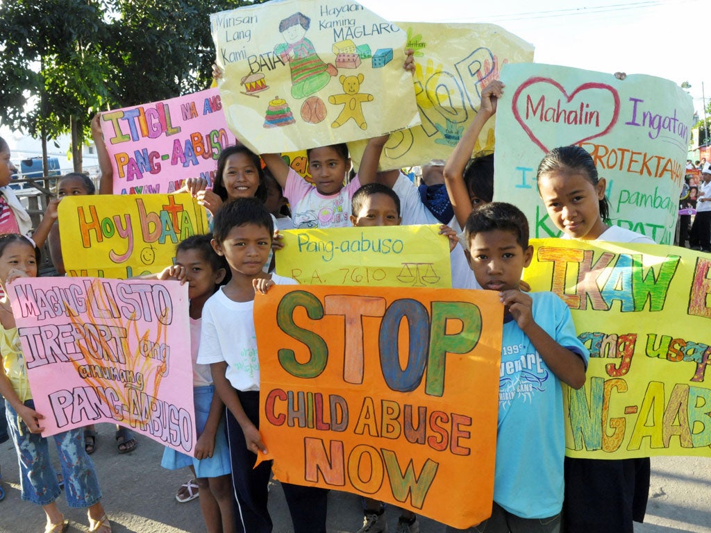 Children from the depressed area of Baseco in Manila on October 17, 2008 carry signs calling for the end of child abuse, in a parade marking United Nations Childrens Month.