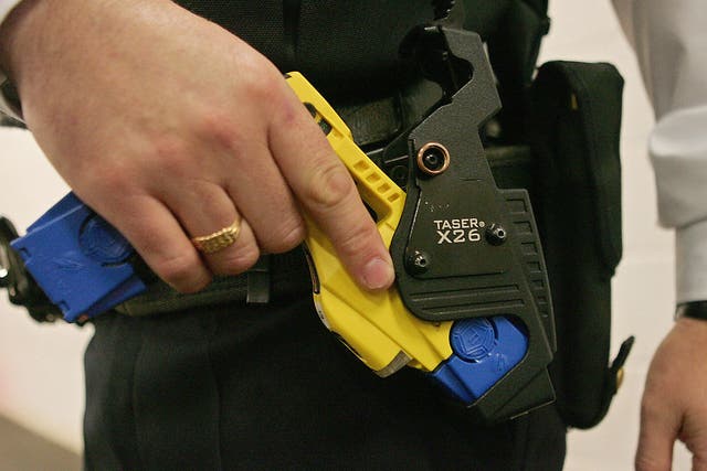 A police officer with a Taser weapon