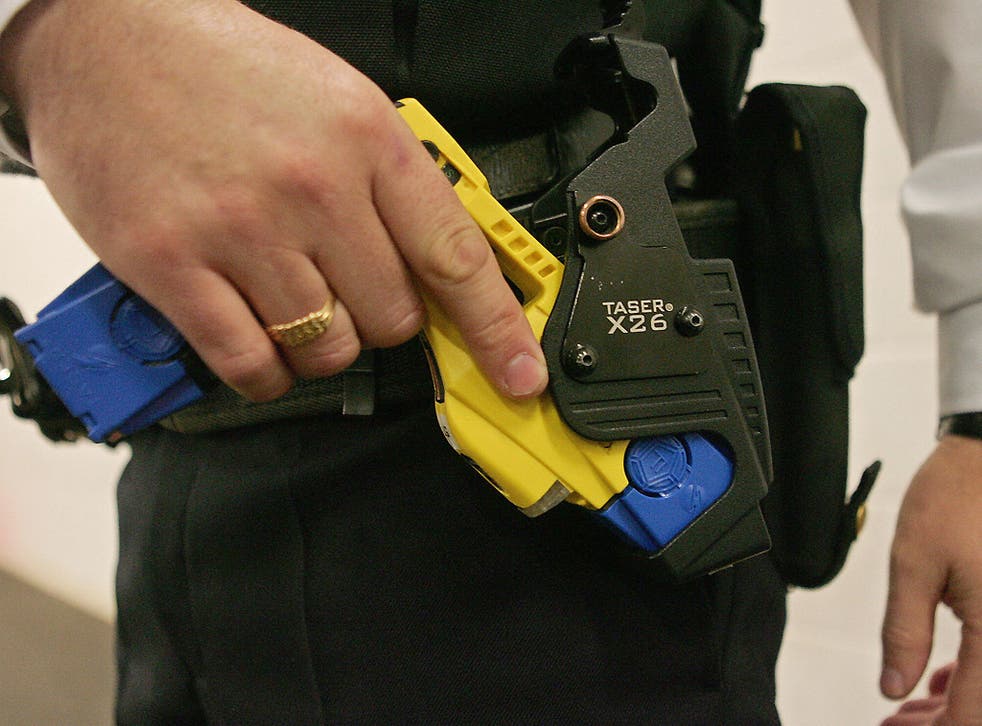 A police officer with a Taser weapon