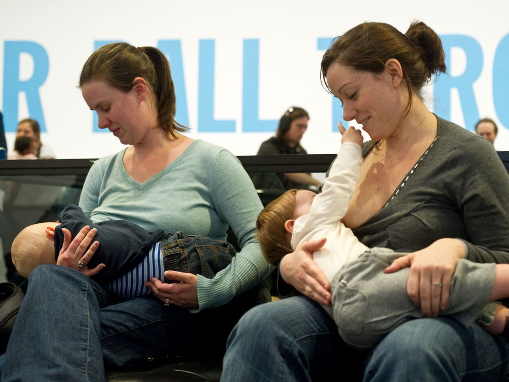 Women breastfeed their babies at the Hirshhorn Museum in Washington on February 12, 2011 during a 'nurse-in'organized after a woman was stopped from nursing in public at the museum