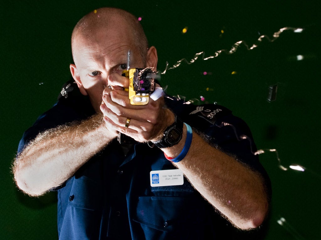 A police officer demonstrates the firing of a Taser