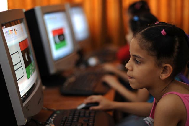 A Libyan girl uses a computer at a school organised by volunteers, Benghazi on June 1, 2011