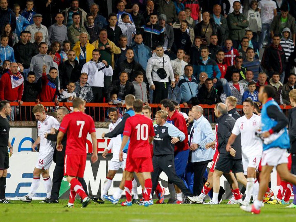 Tom Lees (left) is led off the pitch after the England Under-21s international against Serbia on Tuesday
