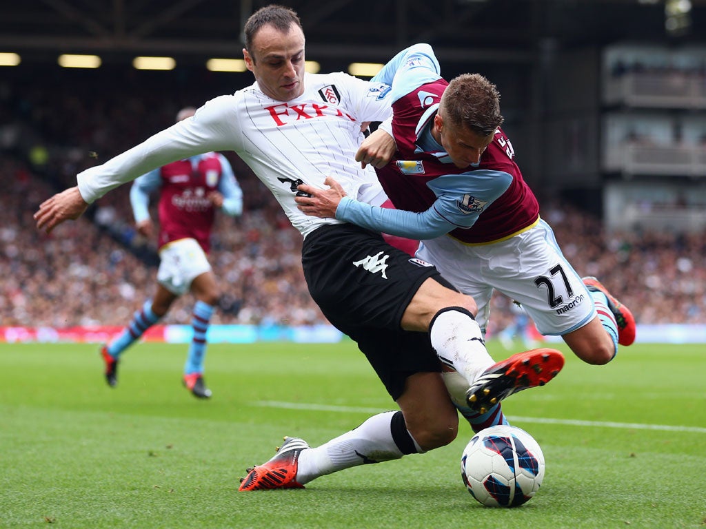Berbatov of Fulham is challenged by Joe Bennett of Aston Villa