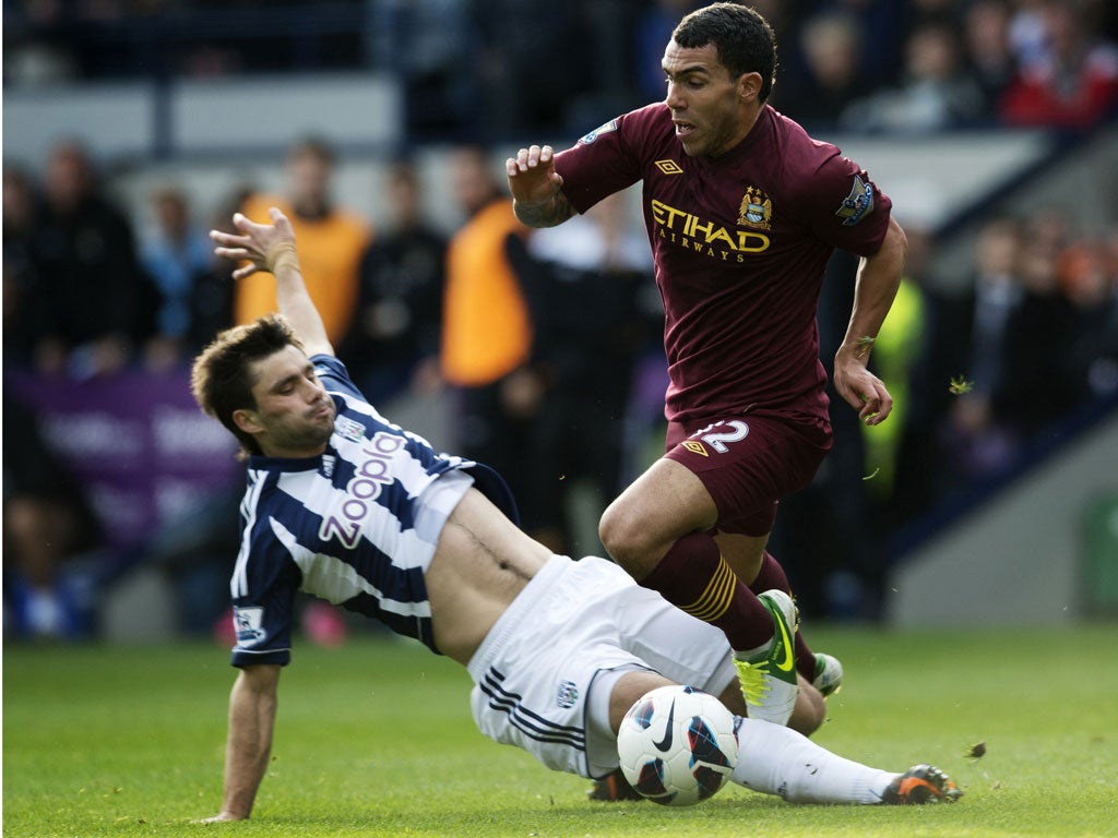 Carlos Tevez runs with the ball during Manchester City's game with West Brom