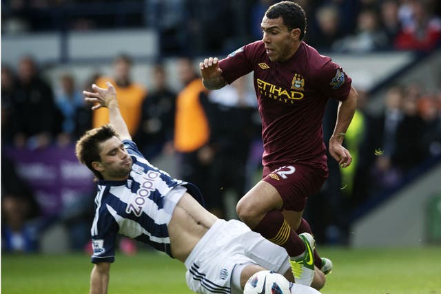 Carlos Tevez runs with the ball during Manchester City's game with West Brom