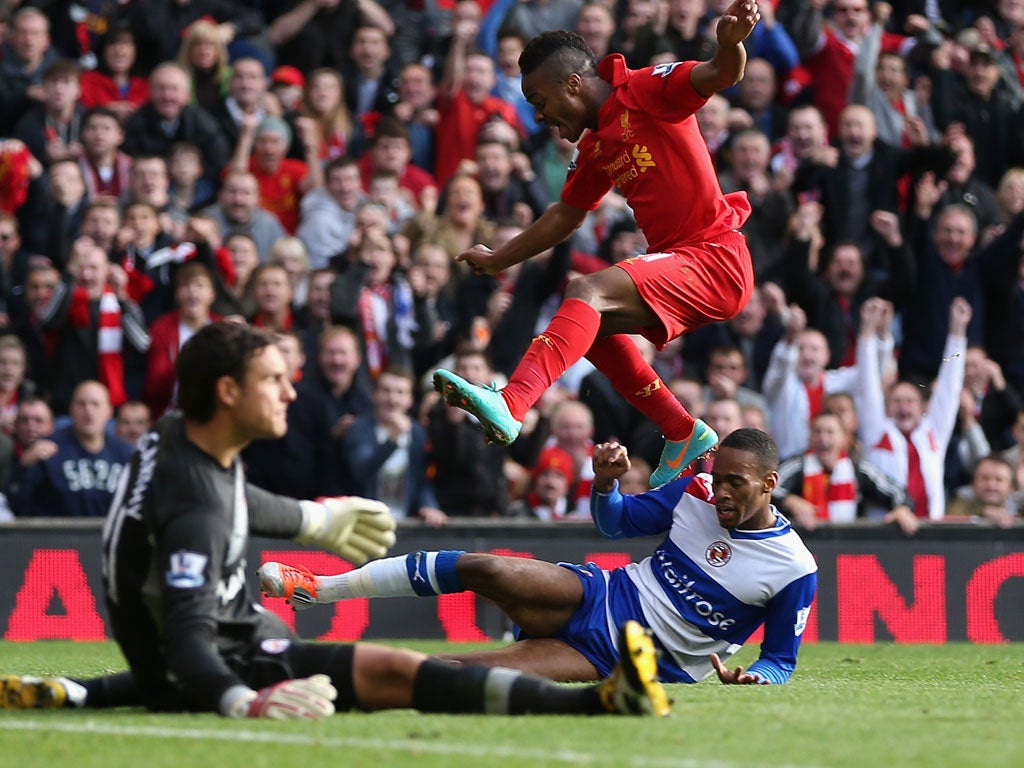 Raheem Sterling hurdles the Reading keeper to score his side's goal