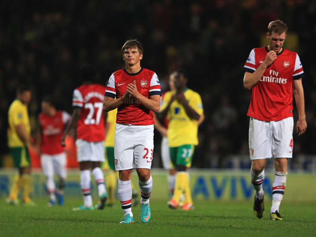 Andrey Arshavin and Per Mertesacker of Arsenal look dejected in defeat