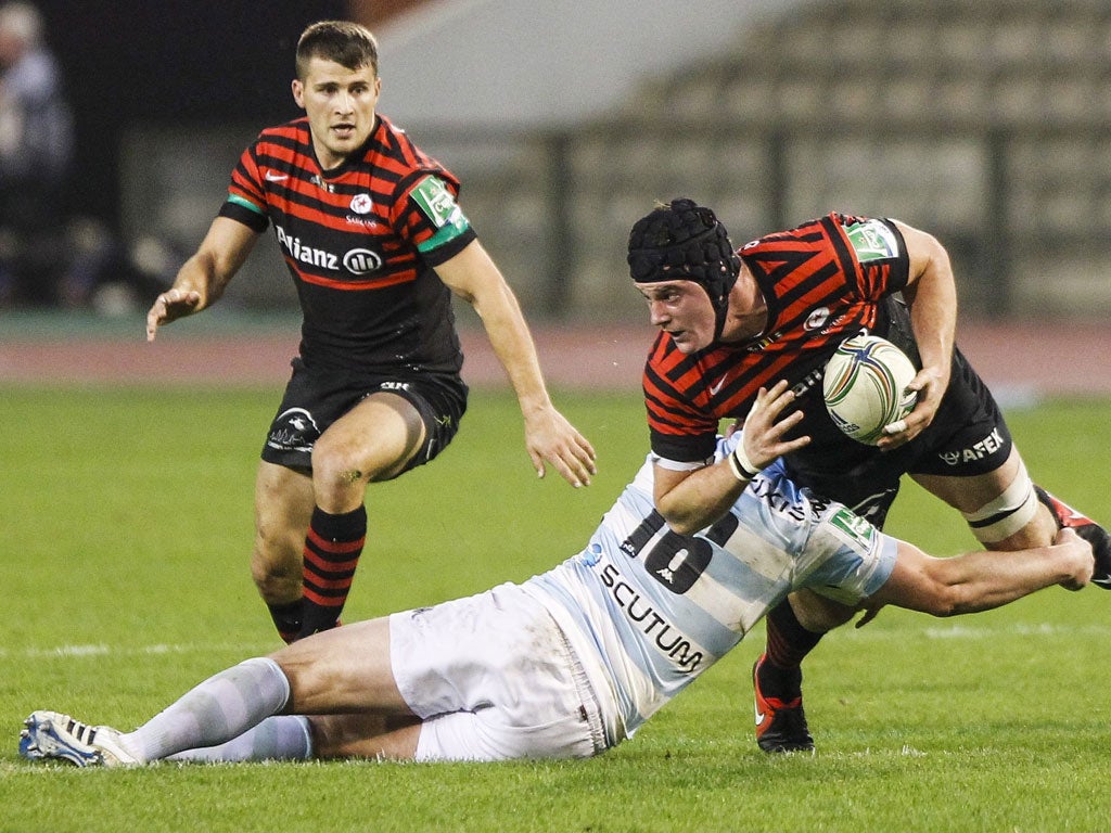 Having a ball: Andy Saull, the Saracens flanker is tackled by Racing Metro's Benjamin Noirot