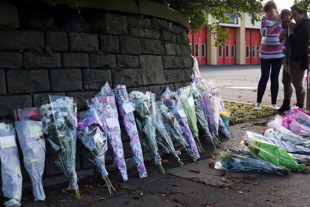 Flowers left at the spot next to Ely fire station, Cardiff, where Karina Menzies was killed on Friday