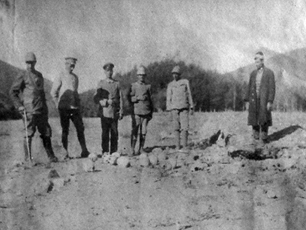 German and Turkish officers pose with the skulls of Armenian victims