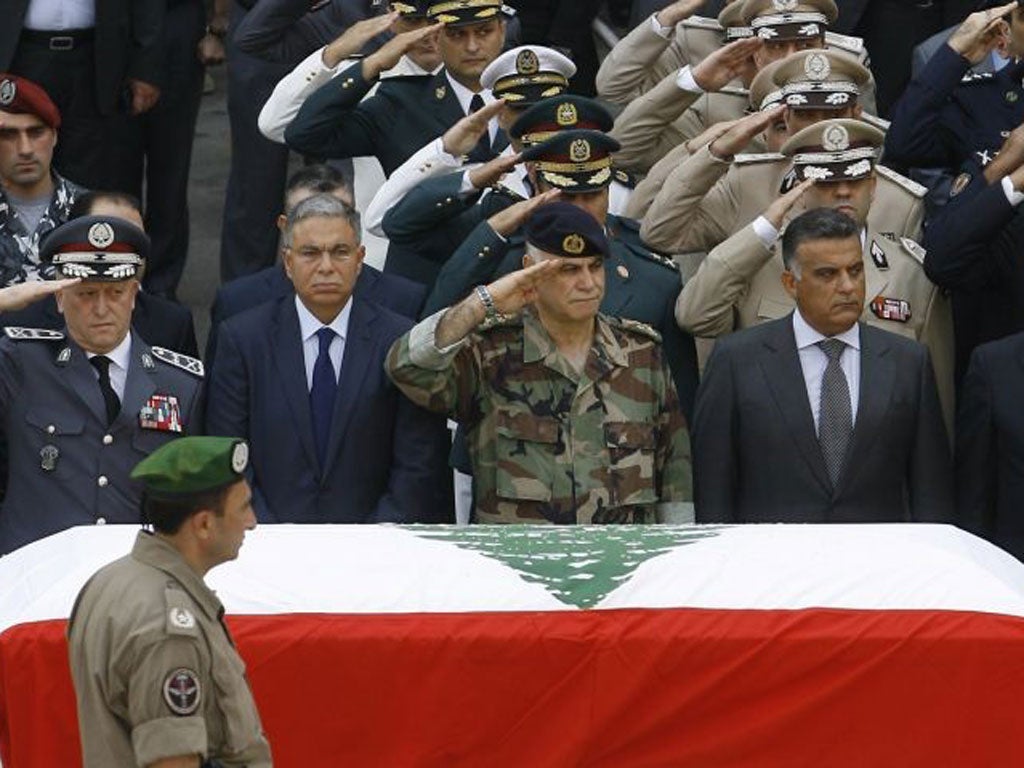 Top Lebanese military brass salute during the funerals of top intelligence chief General Wissam al-Hassan and his bodyguard outside the headquarters of the Internal Security Forces ahead of their funeral procession in downtown Beirut