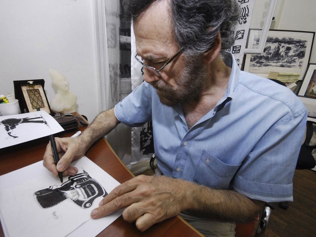Ali Ferzat works in his atelier in Damascus. He now lives and works in exile in Kuwait