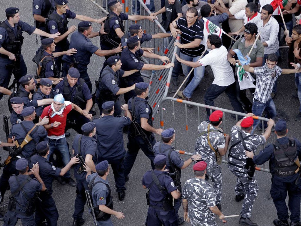 Police and protesters clash after the state funeral of Brigadier-General Wissam al-Hassan in Beirut yesterday