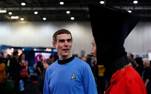 Star Trek fans walk through the exhibition hall at the "Destination Star Trek London" convention in London October 19, 2012. 