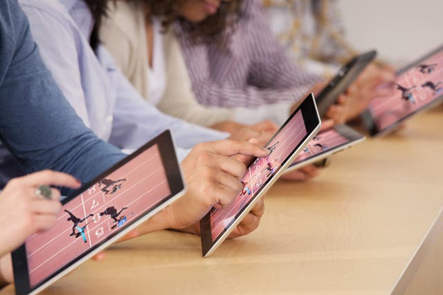 Children use iPads in