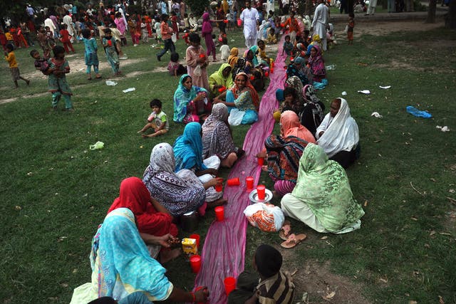 Pakistani Muslim women break their fast at a park in Lahore on July 21, 2102, on the first day of the month of Ramadan.