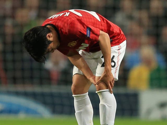 Shinji Kagawa holds his knee during the Champions League match against Braga