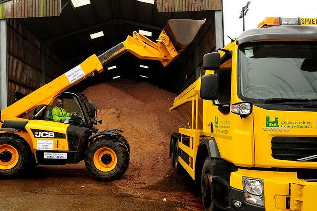 A gritting truck is loaded with a stockpile of salt and molasses mixture used for road gritting at the Northern Highway Depot, Mountsorrel, Leicestershire