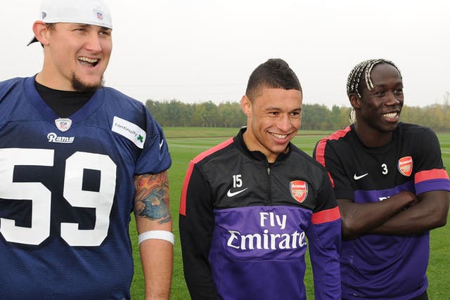 Bacary Sagna and Alex Oxlade-Chamberlain of Arsenal pictured training with Rob Turner of the St Louis Rams earlier today to promote the weekend's NFL game at Wembley