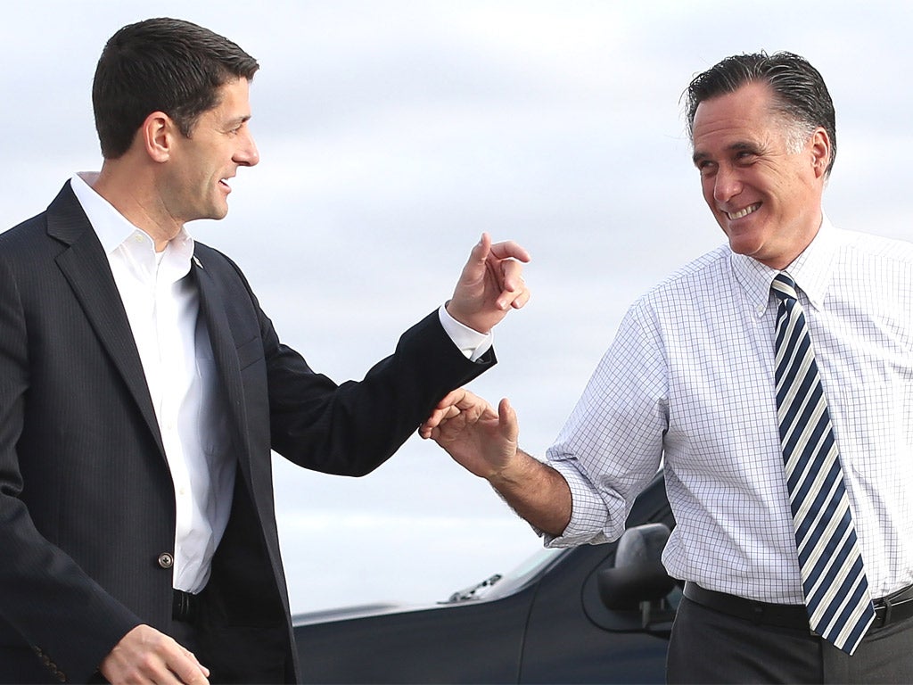 Mitt Romney and his running mate Paul Ryan in Denver yesterday. Romney campaign donors, and his son Tagg, have been linked to voting machine manufacturer, Hart InterCivic