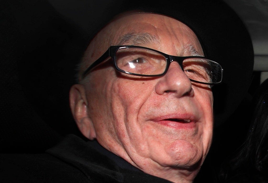 News Corp Chief Rupert Murdoch drives away from the High Court in central London on April 25, 2012 after giving evidence at the Leveson Inquiry.