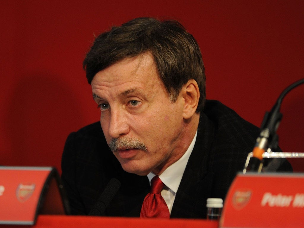 Arsenal's majority shareholder Stan Kroenke said he was committed to winning trophies after he was accused at an AGM