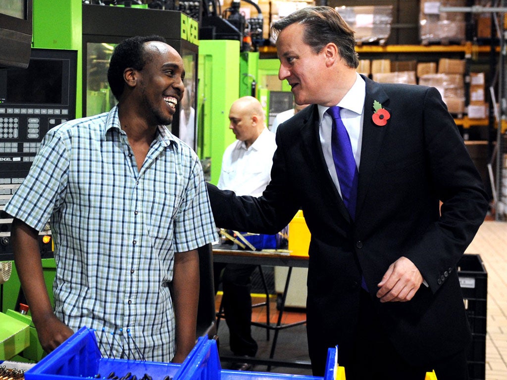 The Prime Minister meets moulding supervisor Ali Alasow during a visit to Panorama Antennas in Wandsworth, south-west London, on the day Britain returned to growth for the first time since 2011