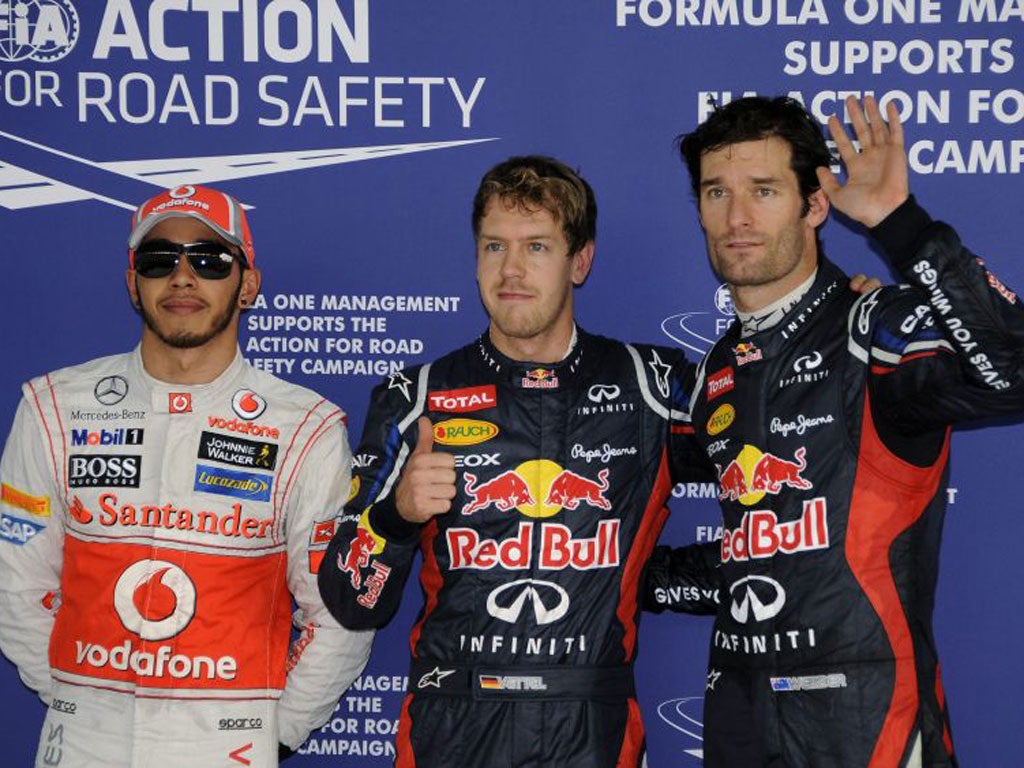 Vettel, centre, with Lewis Hamilton, left, and Mark Webber, right